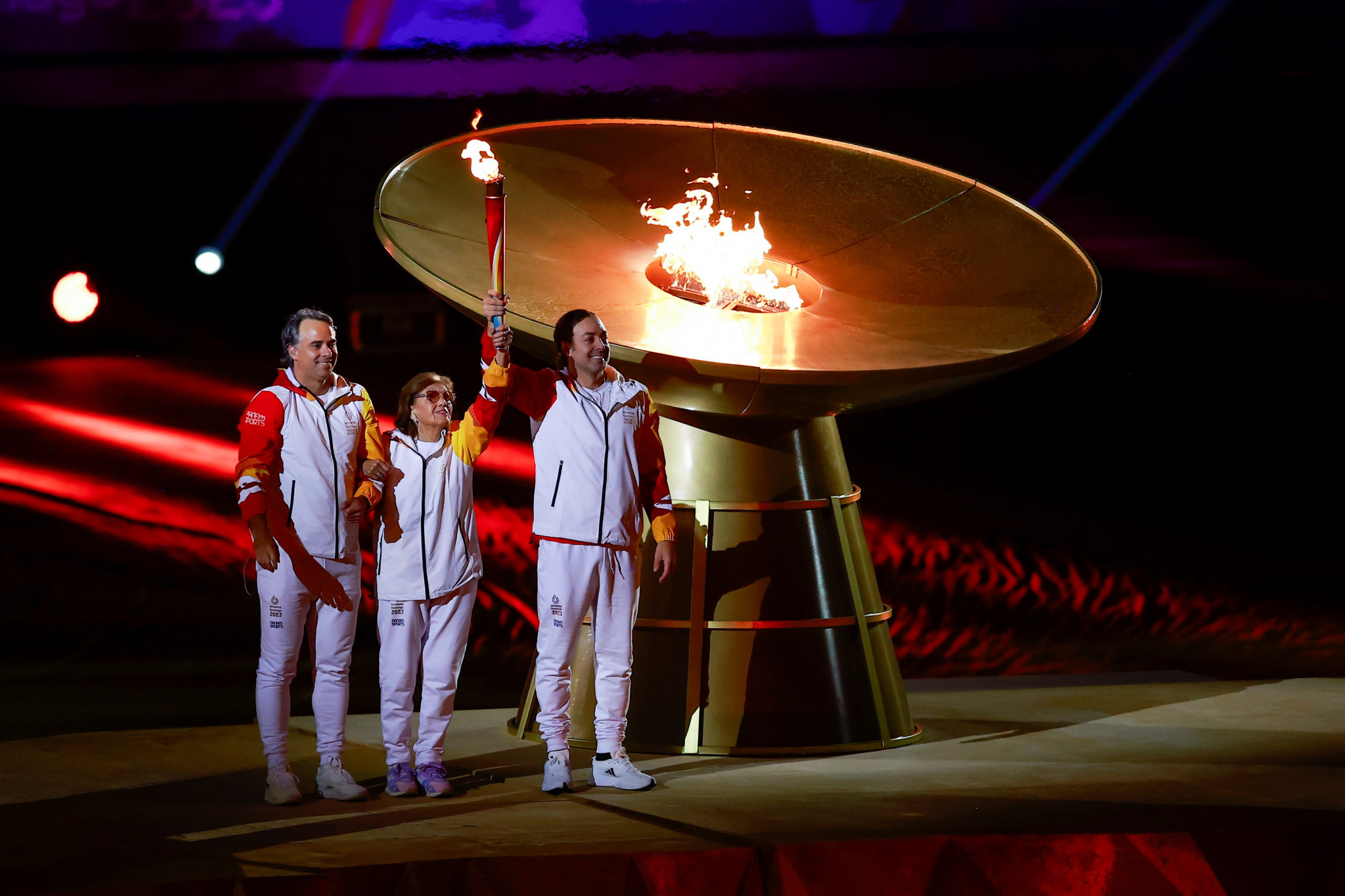 Lucy Lopez, centre, winner of the women's high jump silver medal at the inaugural Pan American Games at Buenos Aires in 1951, walked with Chile's first Olympic gold medallists, tennis stars Nicolas Massu, right, and Fernando González, left, to light the Cauldron ©Santiago 2023