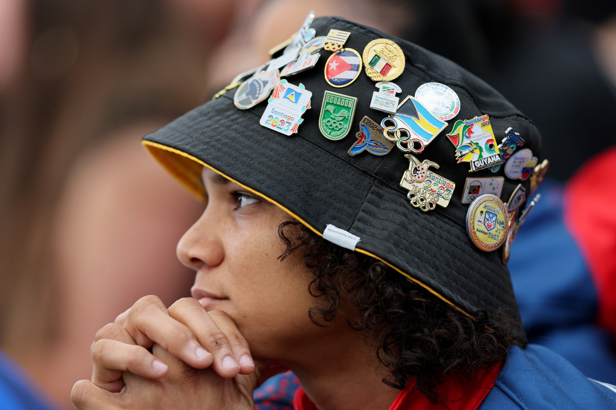 A spectator shows off pin badges while watching the action ©Getty Images 