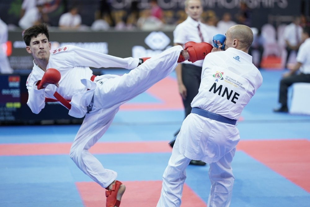 Montenegro's Nenad Dulovic, right, receives a blow to the face but does enough to advance to the men's under-67kg final ©WKF