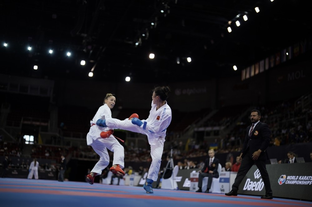 Gong Li of China lands a shot on her way to sealing a spot in the women's under-61kg final ©WKF