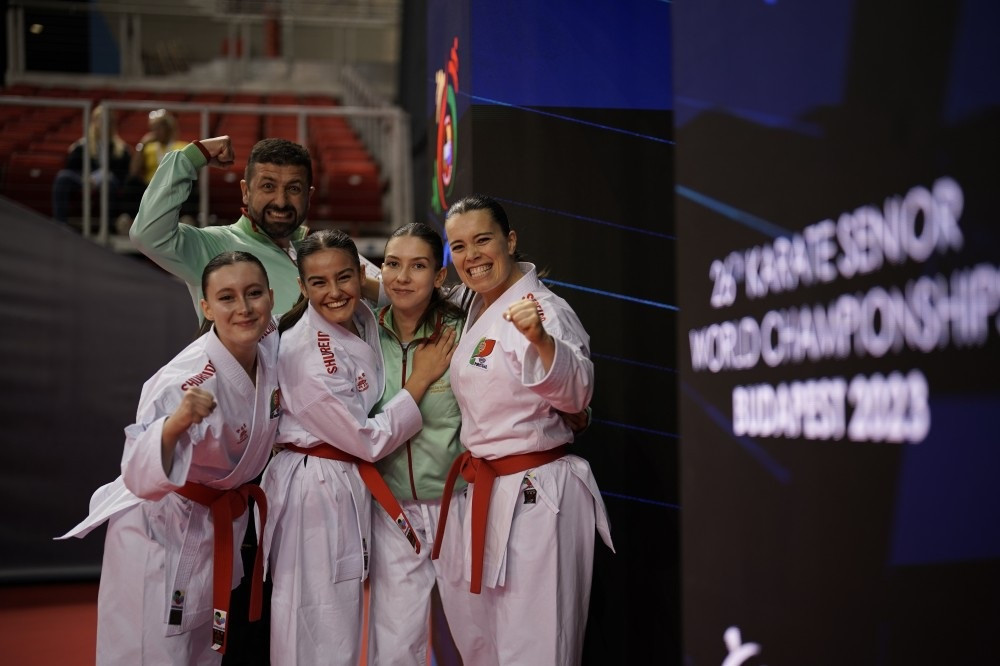 The Portuguese team celebrate a victory in the women's team kumite event ©WKF