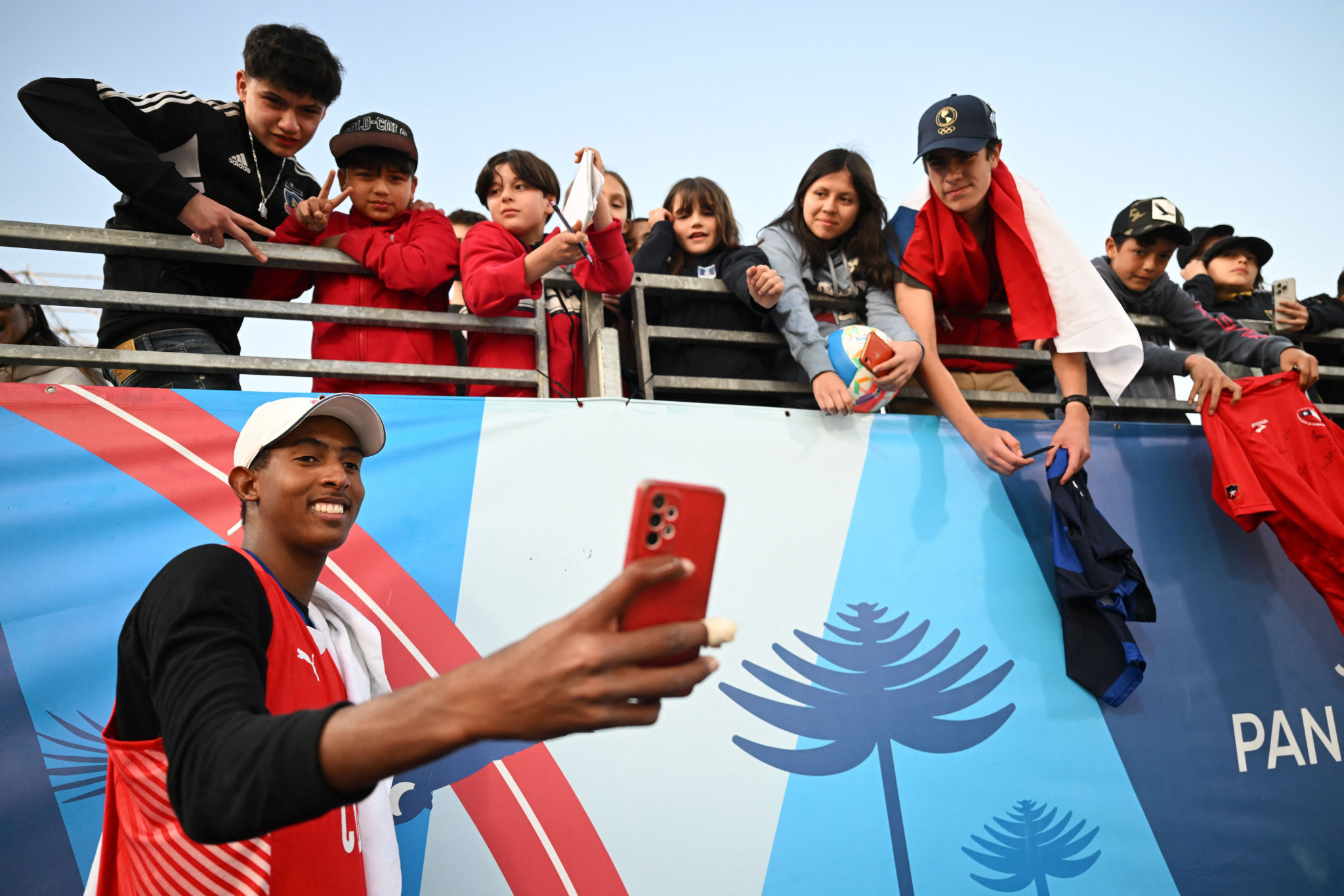 Cuba's beach volleyball player Noslen Diaz stops for a selfie with supporters ©Getty Images