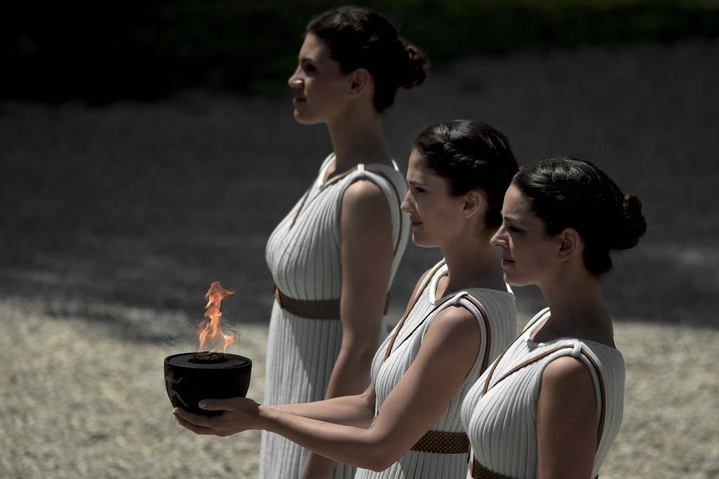  An actress performing as the priestess holds a pot with the Olympic flame ©Getty Images