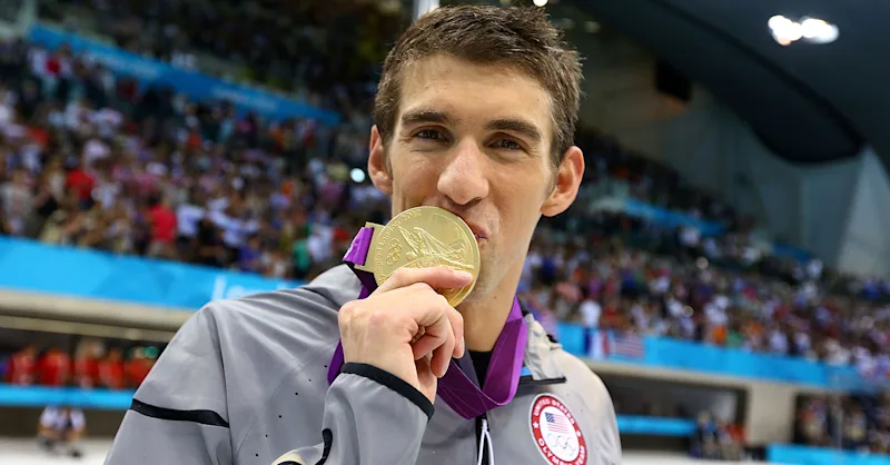 Michael Phelps celebrates taking his Olympic gold medals total to 18 at London 2012 - he added another five at Rio 2016, despite having initally retired four years earlier ©Getty Images