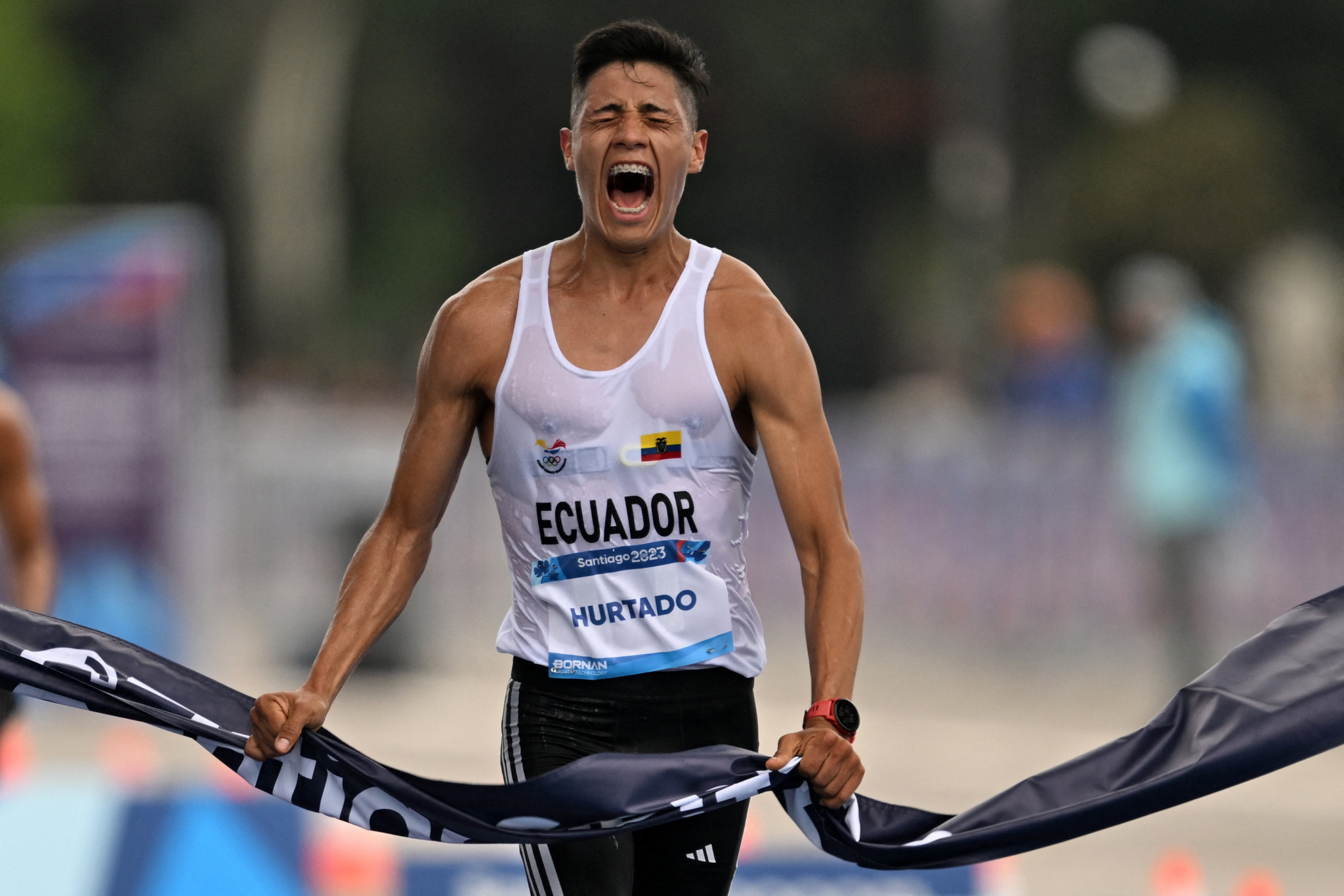 Ecuador's Alexander David Hurtado Espinoza celebrates as he crosses the finish line first in the men's 20km race walk ©Getty Images