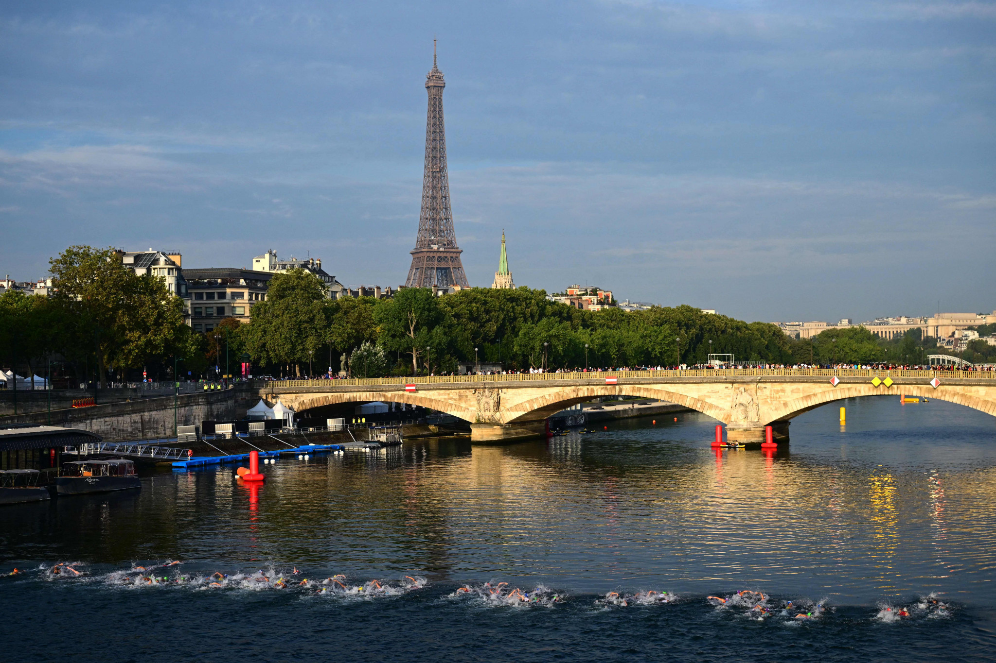 A view as athletes swim in the Seine river in front of the Pont Des Invalides during the Women World Triathlon in Paris © Getty Images