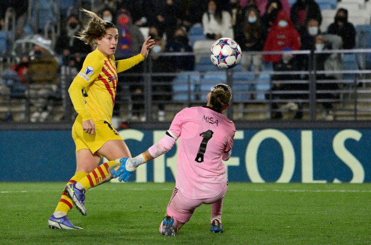 Barcelona's Spanish midfielder Alexia Putellas (L) scores her team's third goal during the women's UEFA Champions League quarter final first leg football match between Real Madrid CF and FC Barcelona at the Alfredo di Stefano stadium in Madrid on March 22, 2022. © Getty Images