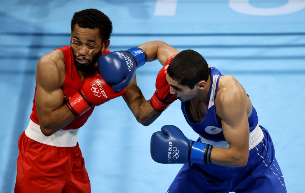 Duke Ragan (red) of Team United States exchanges punches with Albert Batyrgaziev of Team Russian Olympic Committee during the Men's Feather (52-57) final on day thirteen of the Tokyo 2020 Olympic Games. © Getty Images