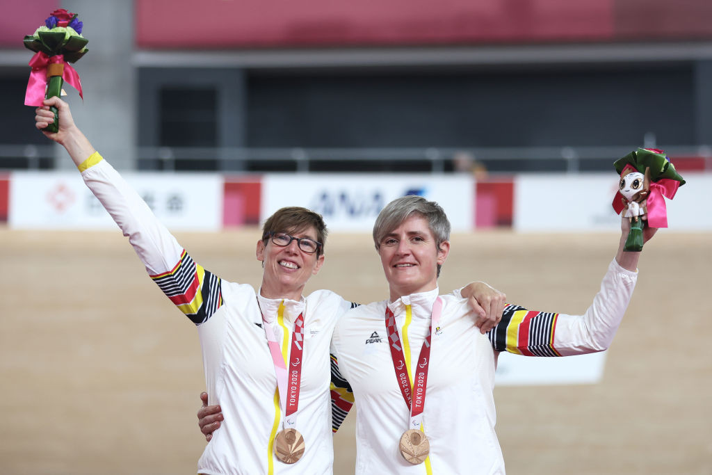 Bronze medalists Griet Hoet (L) and pilot Anneleen Monsieur of Team Belgium celebrate on the podium during the medal ceremony for the Track Cycling Women's B 1000m Time Trial on day 2 of the Tokyo 2020 Paralympic Games at Izu Velodrome on August 26, 2021 