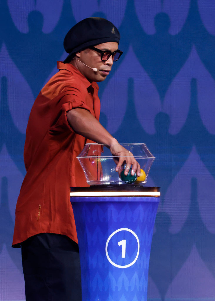 MIAMI, FLORIDA - DECEMBER 07: Brazilian former player Ronaldinho draws a ball during the official draw of CONMEBOL Copa America 2024 at James L. Knight Center on December 07, 2023 in Miami, Florida. (Photo by Eva Marie Uzcategui/Getty Images)
