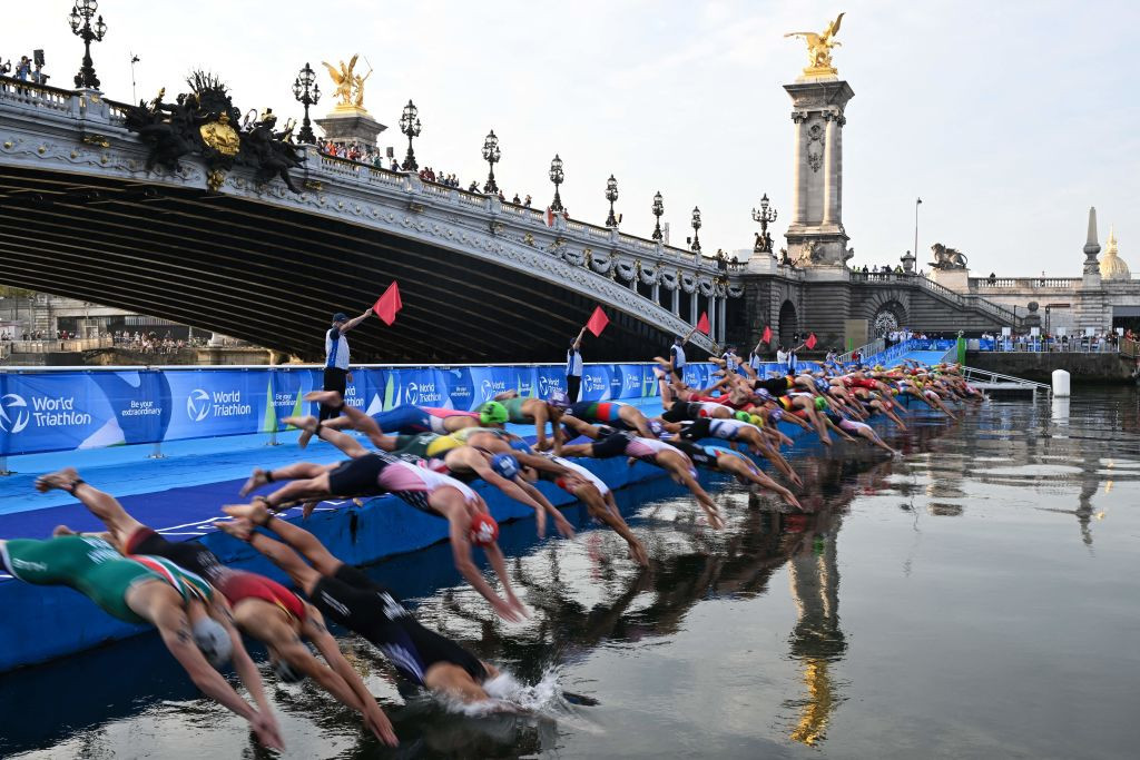 Triathlon athletes dive in the Seine river during the men's 2023 World Triathlon Olympic Games Test Event in Paris, on August 18, 2023. GETTY IMAGES