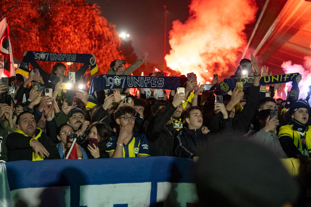 Turkish fans light smoke flares as they wait for the arrival of Fenerbahce football team in Istanbul. GETTY IMAGES