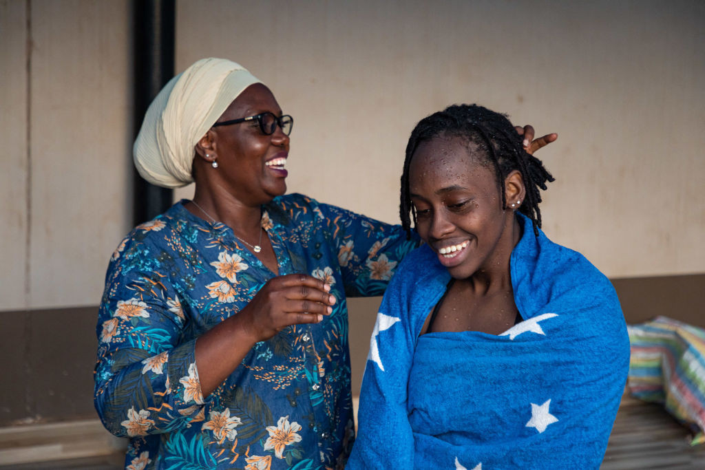 Uganda's Husnah Kukundakwe, 16, talks with her mother Hashima Patience Batamuriza, who doubles as her manager. GETTY IMAGES