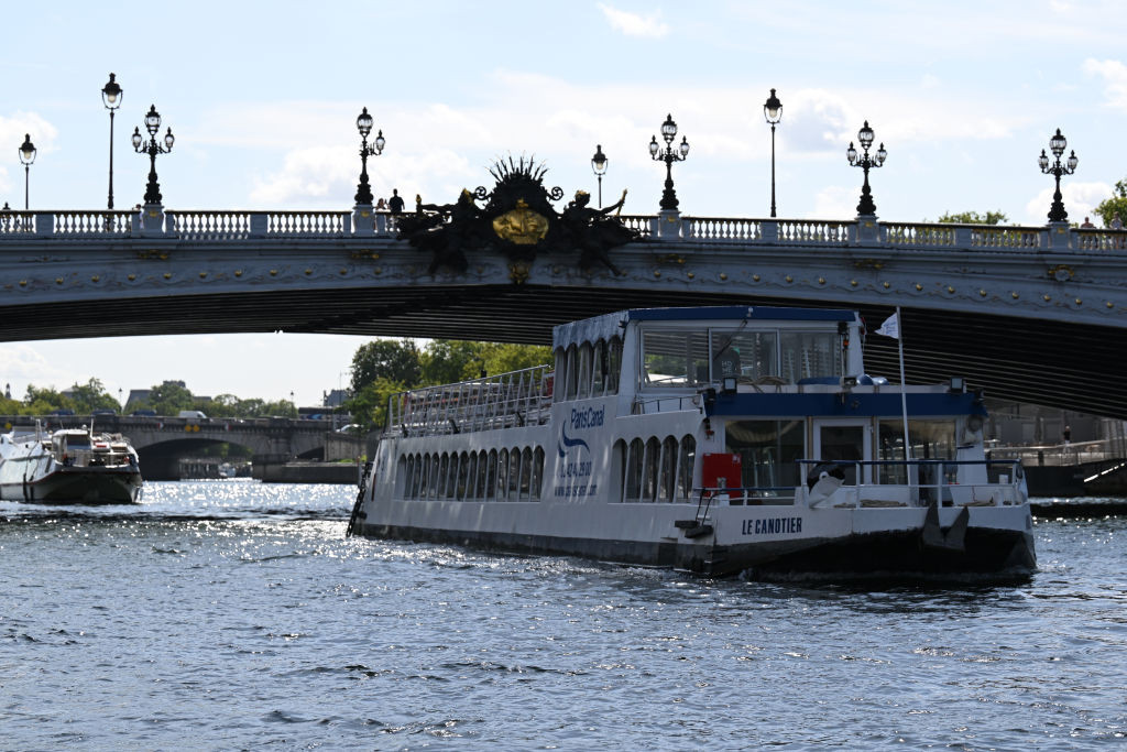 An empty boat passes the Pont Alexandre III on the river Seine during the technical test event for the Paris 2024 opening ceremony. GETTY IMAGES