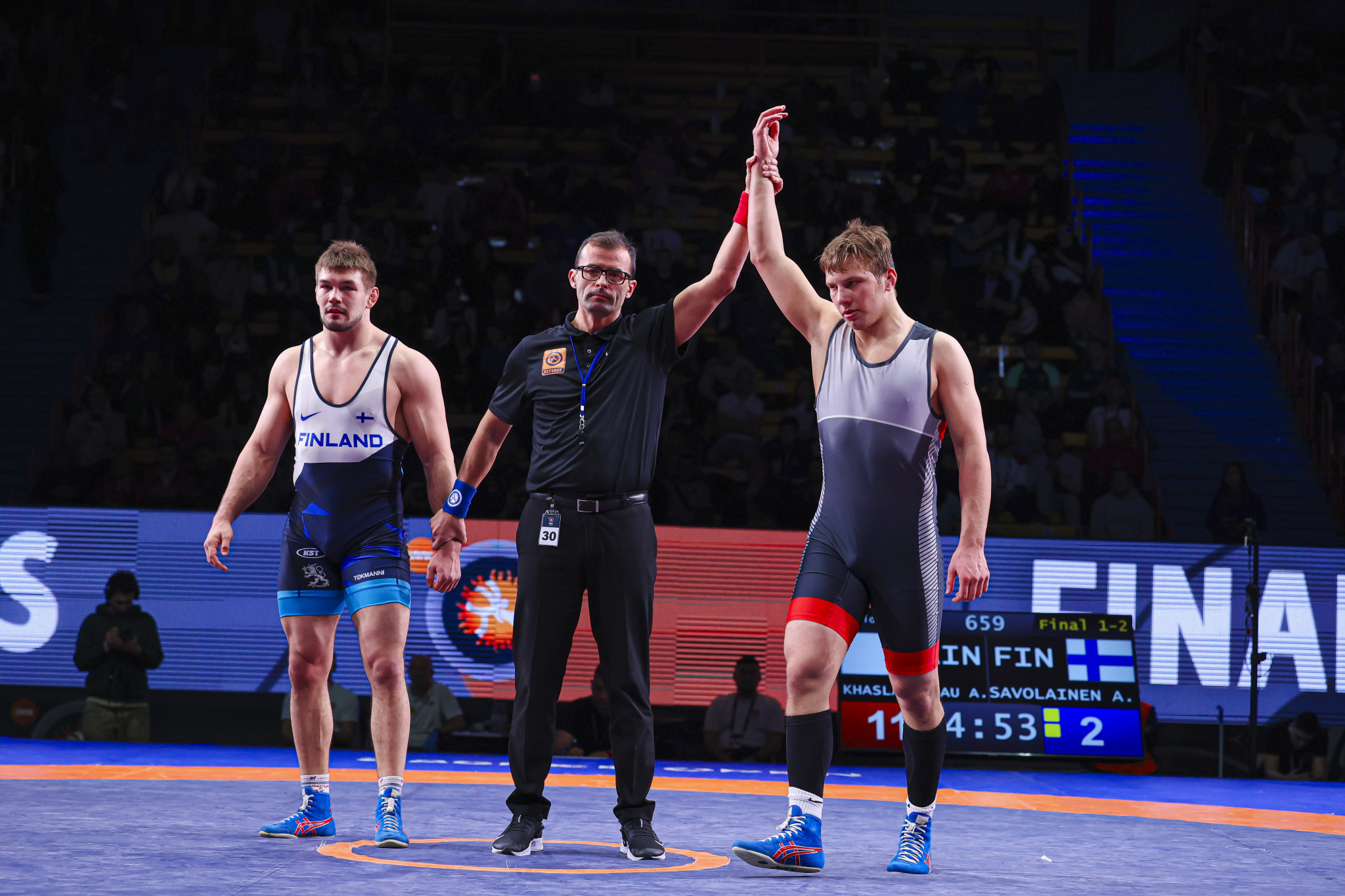 Khaslakhanau (right) after defeating Savolainen in the men's Greco-Roman 97 kg category. UWW 