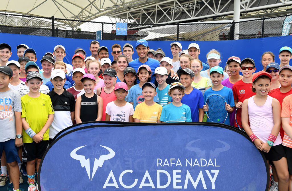 Rafa Nadal poses with young tennis players from his Tennis Academy. GETTY IMAGES