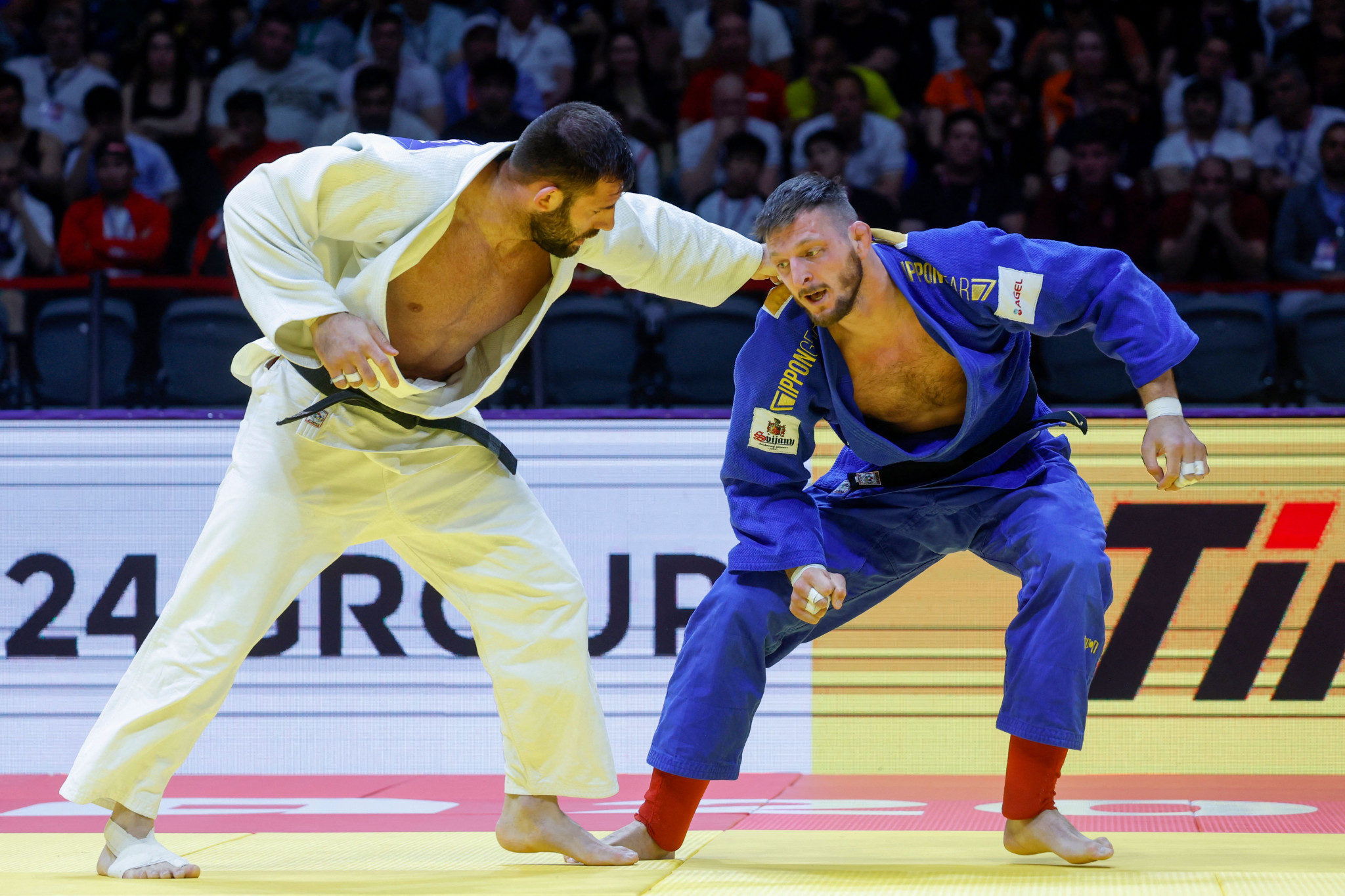 Lukas Krpalek (blue) competes with Russia's Arman Adamian in the men's -100Kg final bout at the 2023 World Judo Championship in Doha © KARIM JAAFAR/AFP via Getty Images