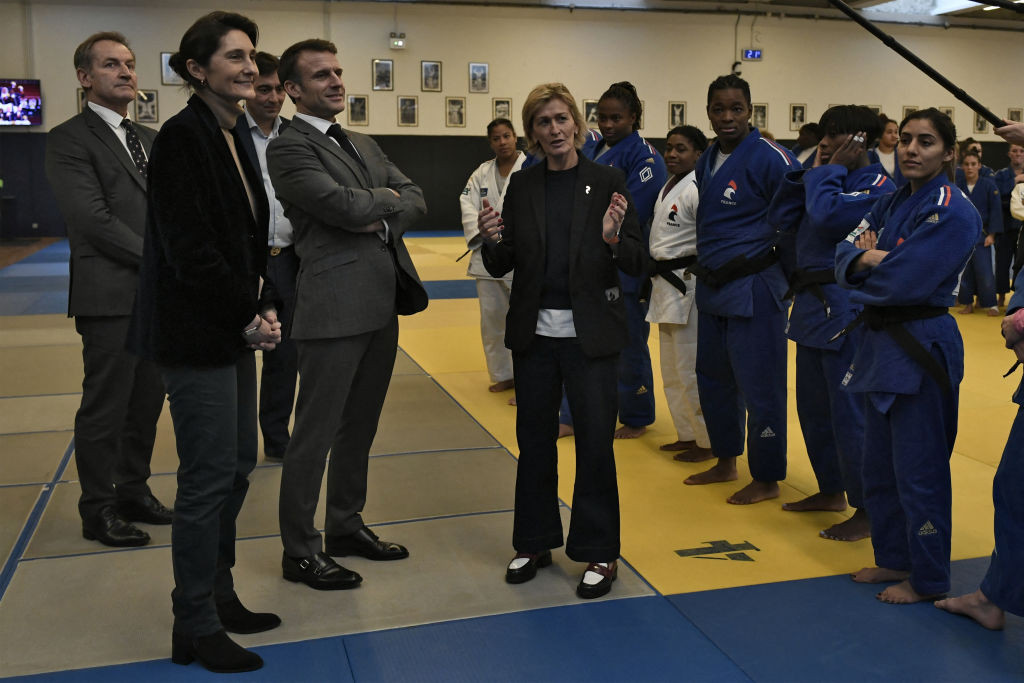 Emmanuel Macron and Amelie Oudea-Castera listen to former French judoka Frederique Jossinet. GETTY IMAGES