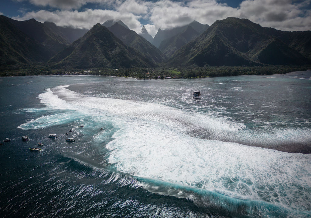 An aerial view surfers and spectator boats in Teahupo'o, French Polynesia. GETTY IMAGES