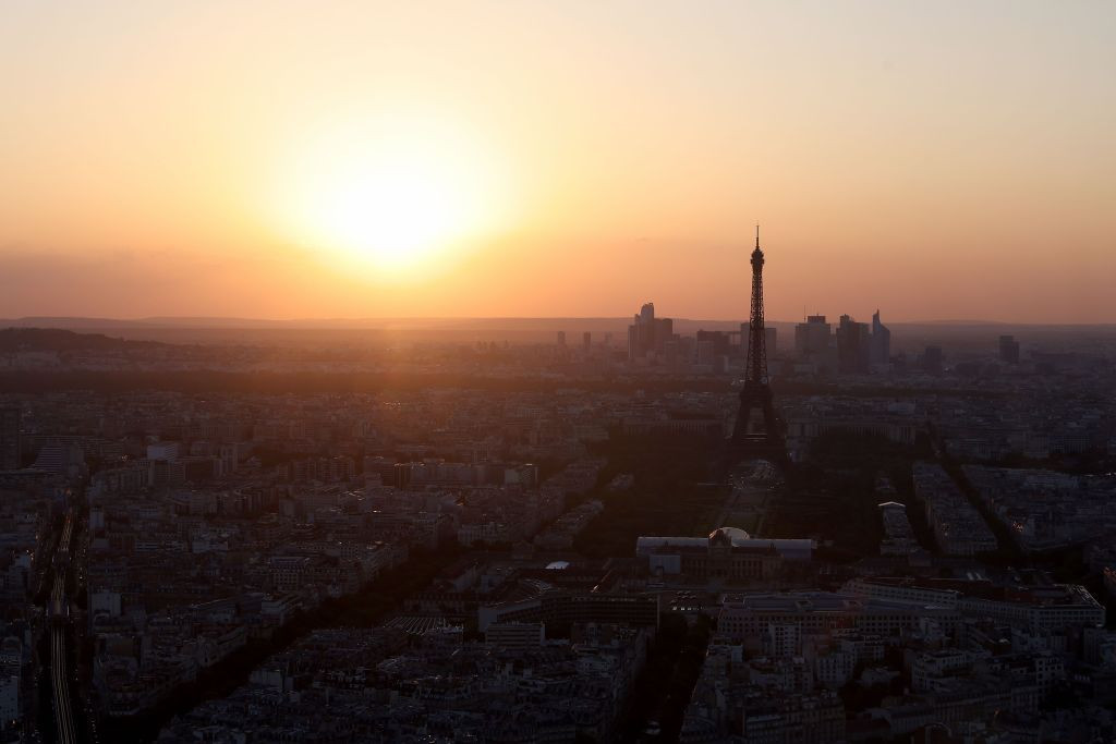 The sun sets behind the Eiffel Tower in Paris on 7 July 2023. GETTY IMAGES