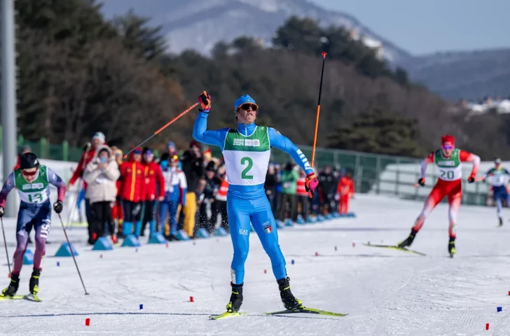 Italy's Federico Pozzi celebrates his victory in the men's cross-country skiing. IOS/IOC.