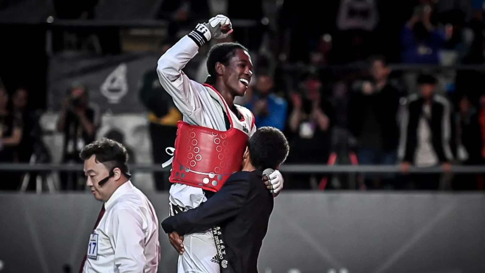 Omar Salim (red) with his father Gergely Salim after winning the 2022 Taekwondo World Championships. WT