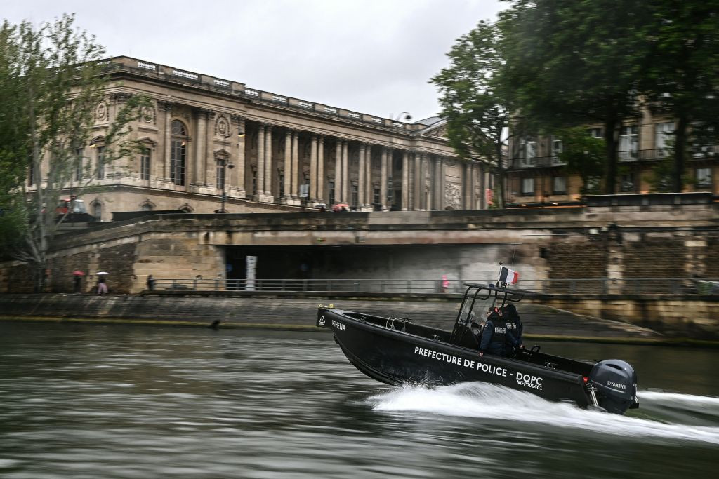 Policemen from the River Brigade (Brigade Fluviale) patrol on a boat on the Seine river, in front of the Louvres' museum in Paris. GETTY IMAGES