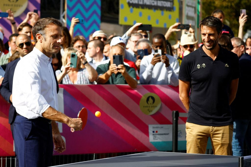 Emmanuel Macron plays table tennis with Paralympic athletes and Tony Estanguet in Paris. GETTY IMAGES