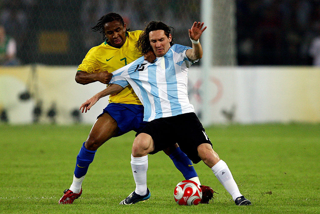 Messi is tackled by Brazil's Anderson in the men's football semifinal at Beijing 2008. GETTY IMAGES