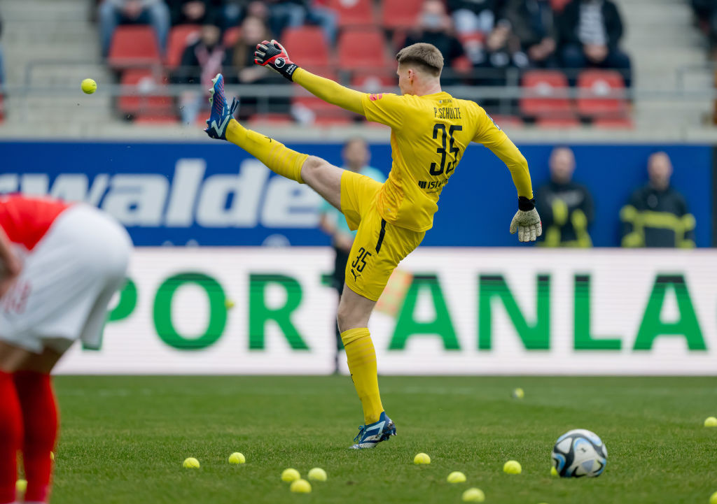 Goalkeeper Philipp Schulze of Halle kicks tennis balls. GETTY IMAGES