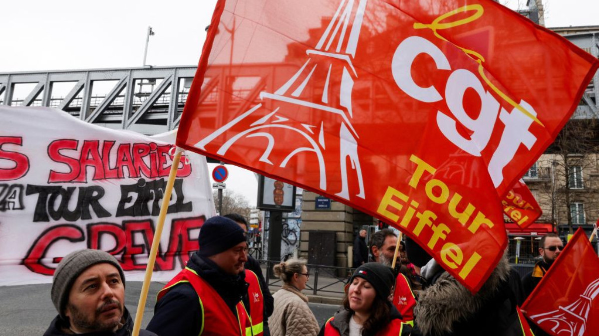 Demonstrators hold CGT union flags at the Eiffel Tower during a workers' strike. GETTY IMAGES