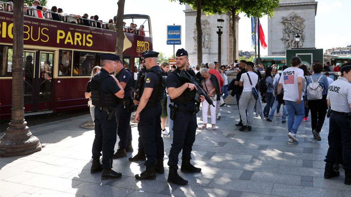 French police stand guard and secure the Champs Elysees Avenue near the Arc de Triomphe in Paris. GETTY IMAGES