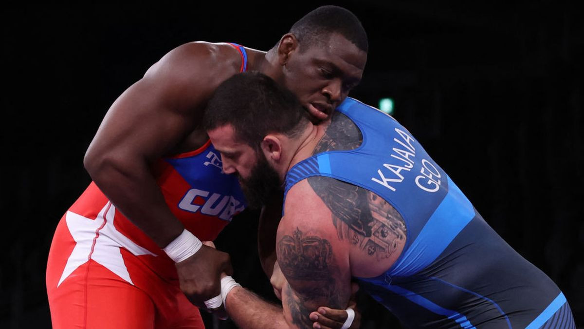 Mijain Lopez (red) and Iakobi Kajaia in the Greco-Roman 130kg final at Tokyo 2020. GETTY IMAGES