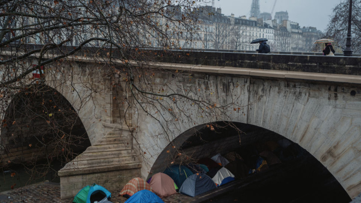 Tents used by African asylum seekers can be seen under the Pont de la Marie. GETTY IMAGES