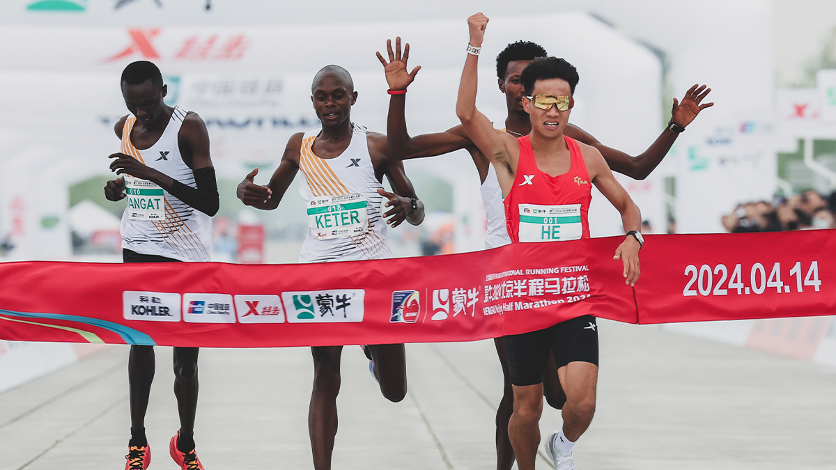 Athletes cross the finish line, with China's He Jie taking first place. BEIJING INTERNATIONAL RUNNING FESTIVAL