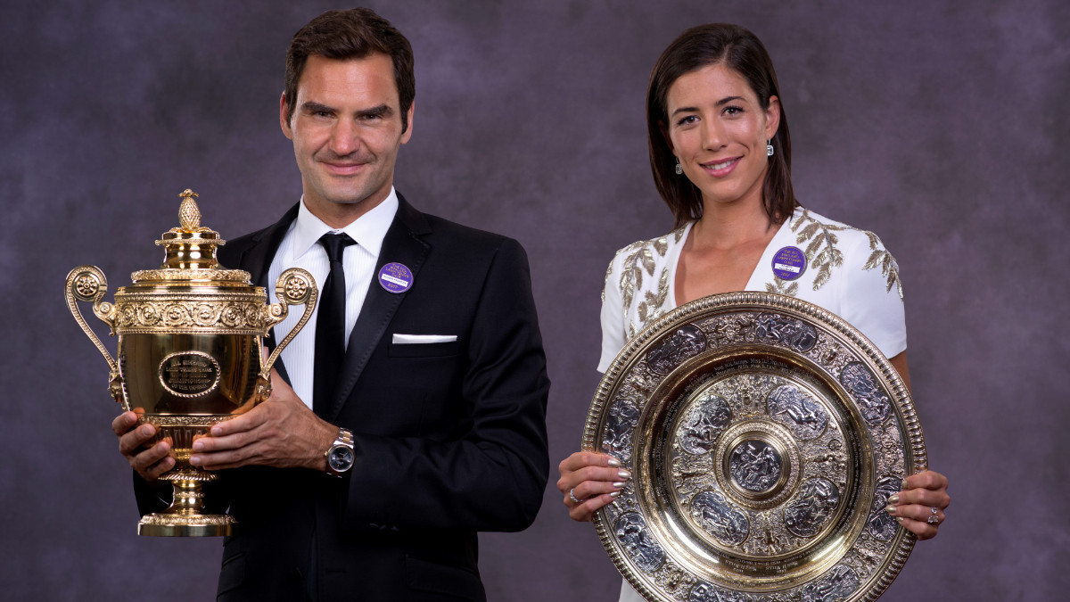 Garbiñe, with Roger Federer as the 2017 Wimbledon singles champions. GETTY IMAGES