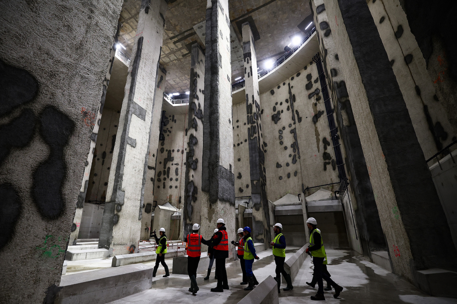Visitors walk inside the construction site of the 30-meter-deep Austerlitz basin, a river Seine water storage and treatment basin, aiming to make the river cleaner for the Paris 2024 Olympic Games. GETTY IMAGES