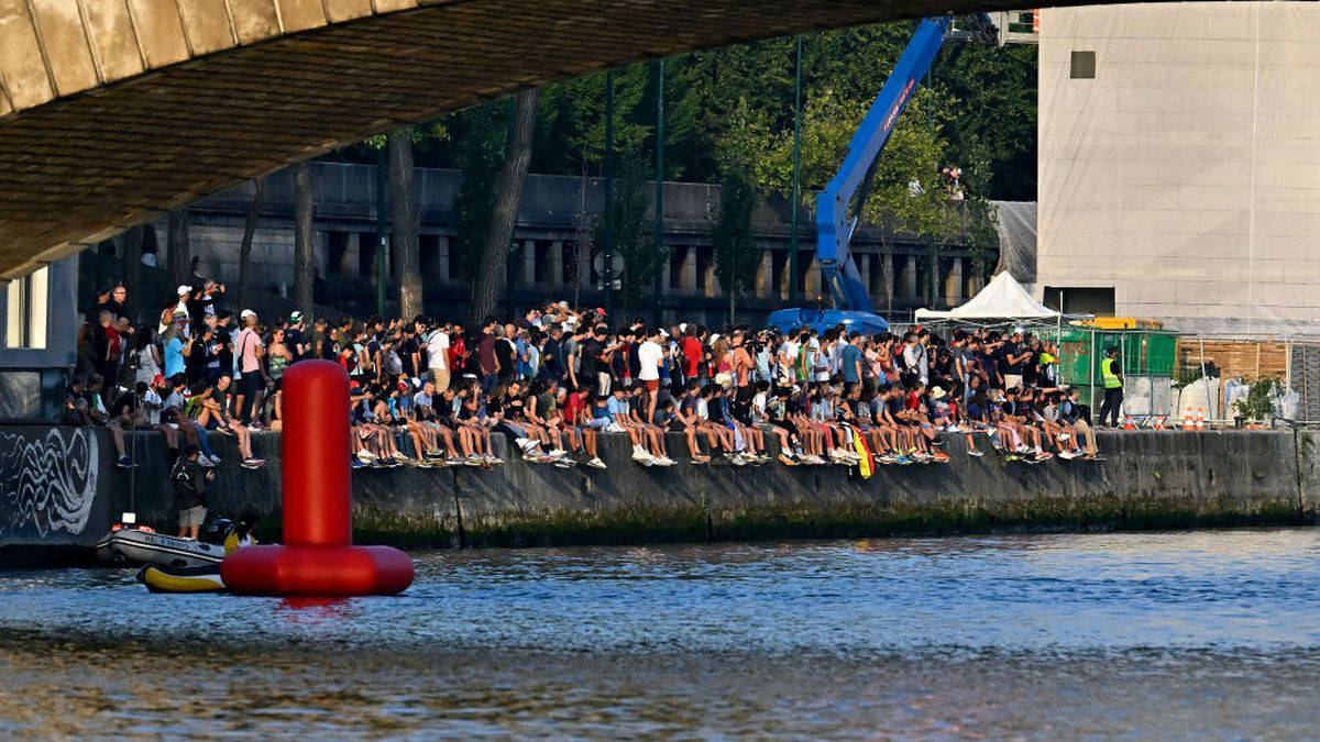 Spectators on the banks as athletes swim in the Seine in August 2023. GETTY IMAGES