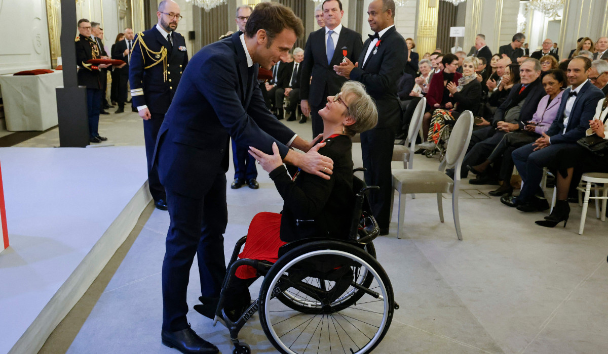 Béatrice Hess, with French President Emmanuel Macron. GETTY IMAGES