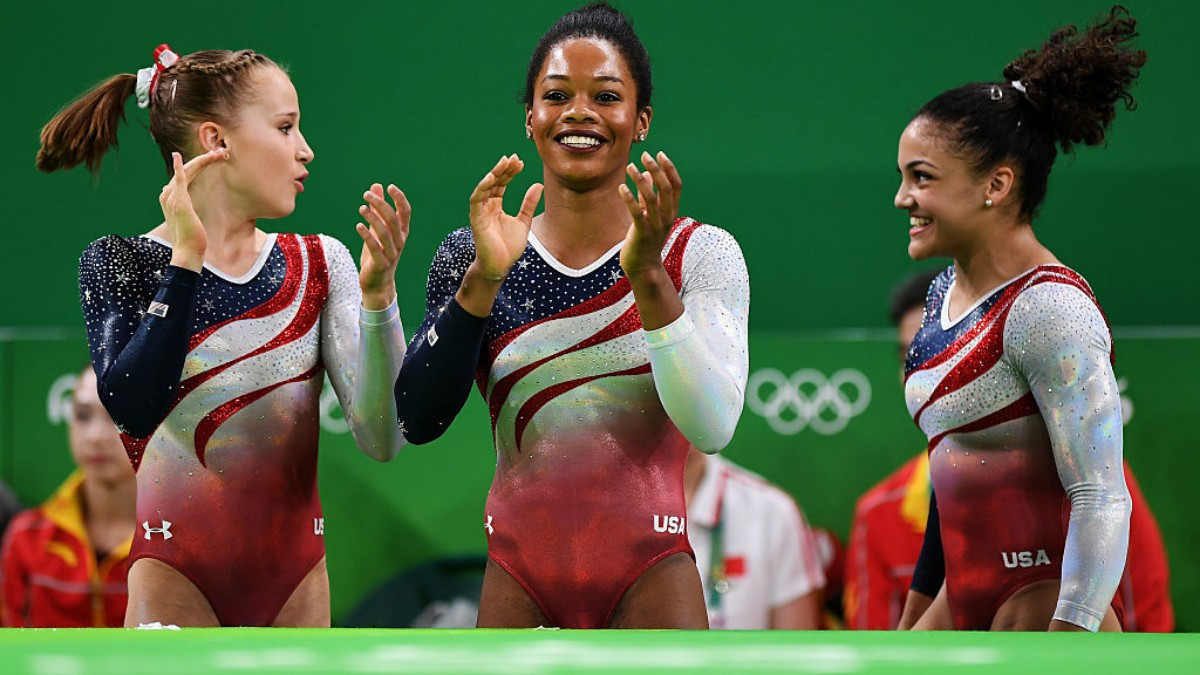 
Gabby Douglas, in the center, after winning one of her golds at London 2012. GETTY IMAGES