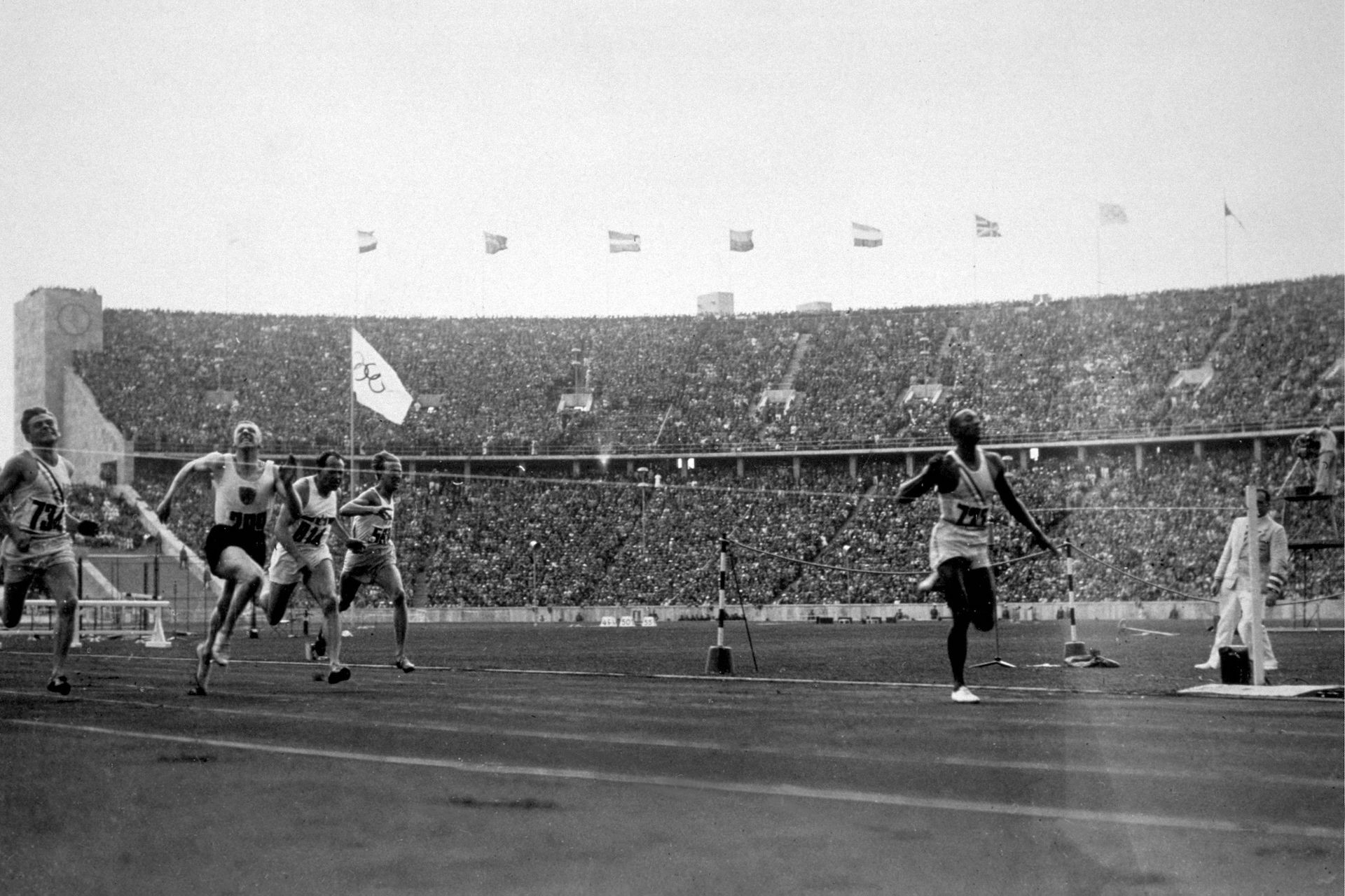 Jesse Owens crosses the finishing line to win the 100 metres at the 1936 Olympics in Berlin. GETTY IMAGES