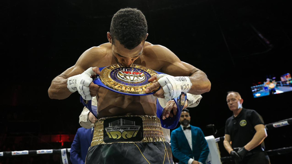 Javier Ibañez Diaz kisses the IBA belt after winning at the Madrid Arena. IBA
