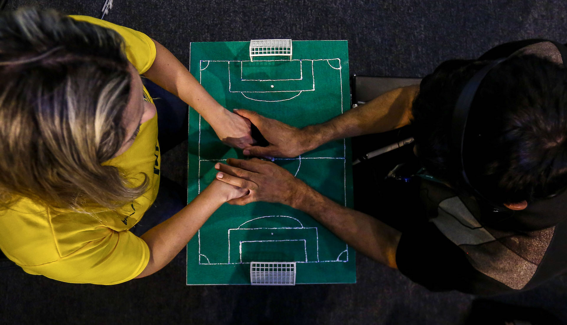 A blind-deaf football fan follows the game with the help of an interpreter. GETTY IMAGES