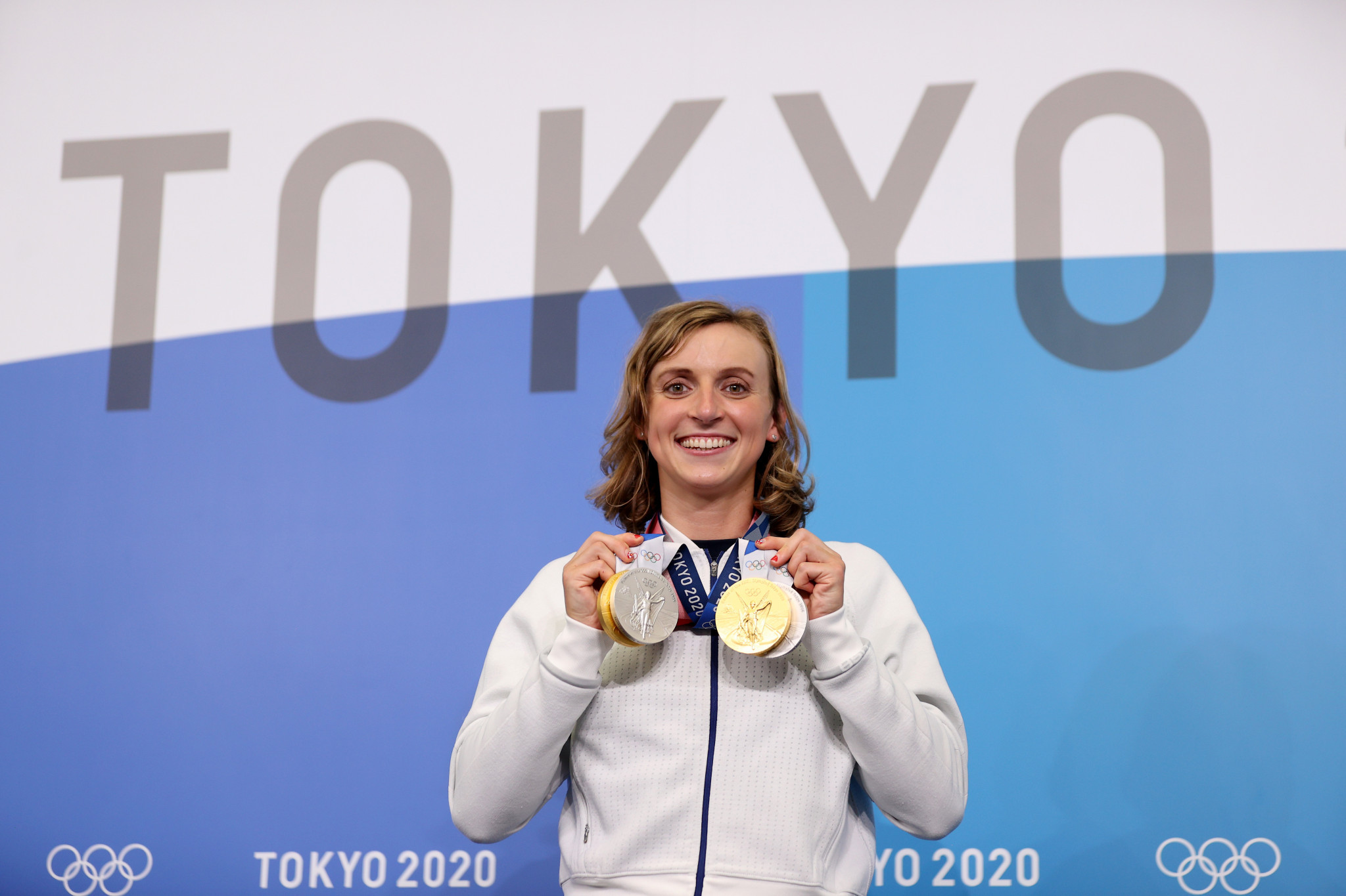 Ledecky poses with her medals at the Tokyo 2020 Olympic Games. GETTY IMAGES