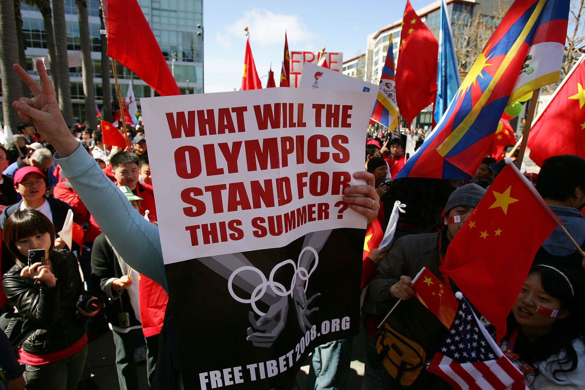 A protester holds a sign as they wait for Olympic Torch to pass. GETTY IMAGES