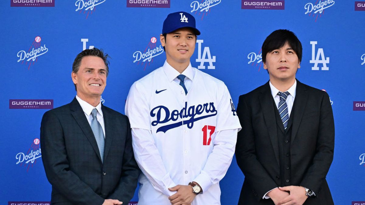 Shohei Ohtani poses with his agent Nez Balelo (L) and interpreter Ippei Mizuhara during a press conference on his presentation  with the Los Angeles Dodgers. GETTY IMAGES