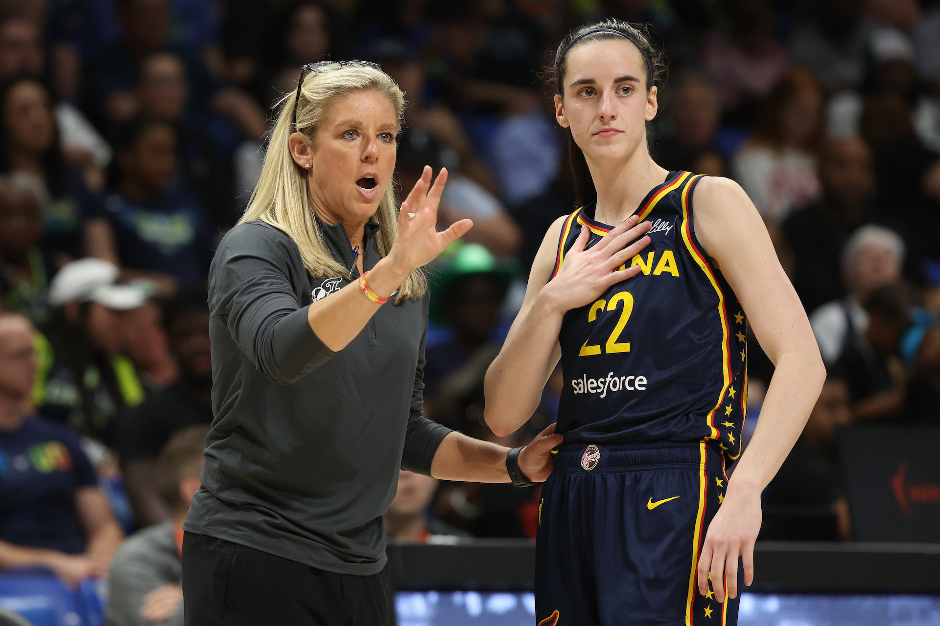 Caitlin Clark talks to head coach Christie Sides while playing the Dallas Wings during a pre-season game that was attended by 13.000 fans. GETTY IMAGES