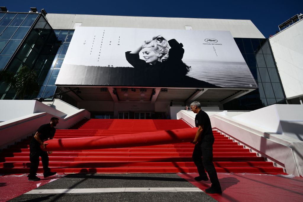 Workers prepare the red carpet ahead of the opening of last year's Cannes Film Festival. This year the Olympic torch will be brought up these famous steps. GETTY IMAGES
