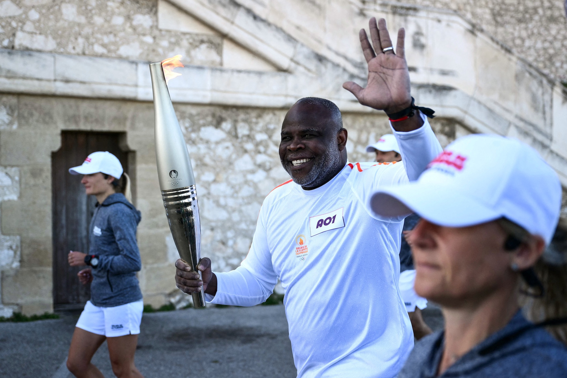 The Olympic Torch is making its way through France. Here former football player Basile Boli takes part of the relay. GETTY IMAGES