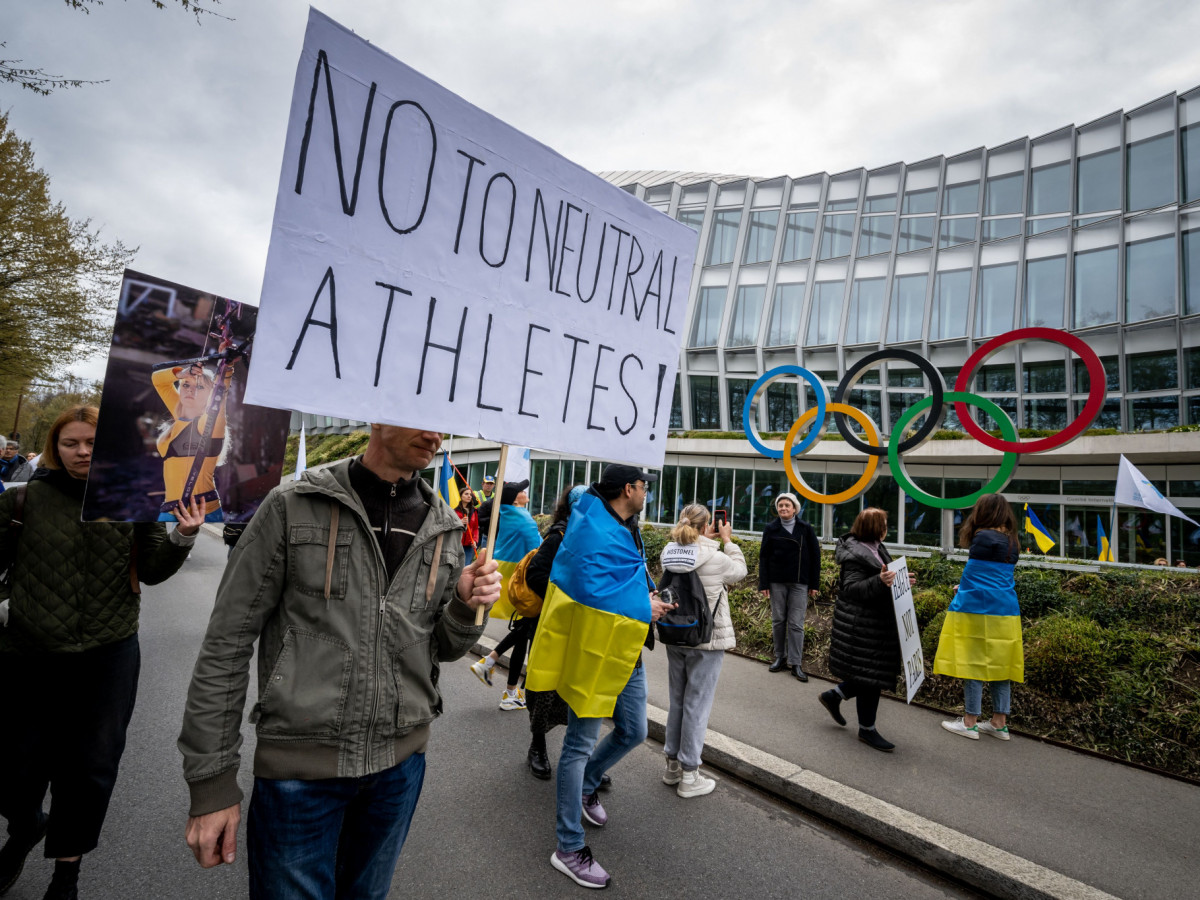 Ukrainians protesters walk past the headquarters of the International Olympic Committee in Lausanne. GETTY IMAGES 